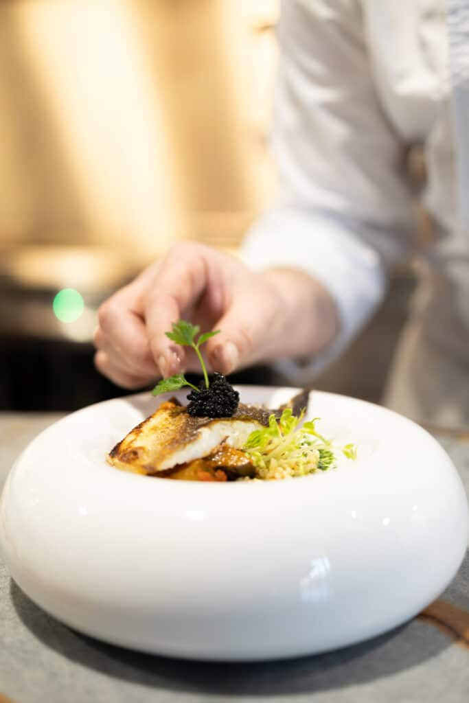 Chef plating dish at fuga restaurant in voco™ Brussels City North-2